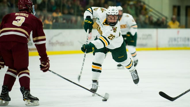 Vermont forward Ross Colton (20) takes a shot during the men's hockey game between the Boston College Eagles and the Vermont Catamounts at Gutterson Field House on Friday night November 10, 2017 in Burlington.