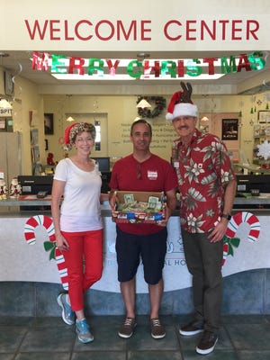 Dr. Robin Waters-Poderski, House of Hope CEO Rob Ranieri and Dr. Karol Poderski at Martin Downs Animal Hospital's Pet Photos with Santa. The event raised more than $500 for House of Hope.