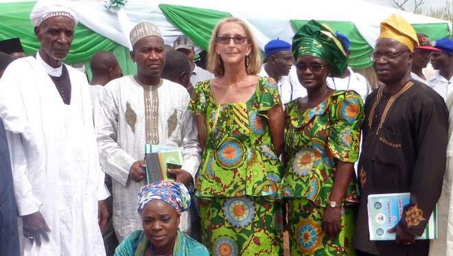 Seattle missionary Rev. Phyllis Sortor, stands at center with a delegation of area dignitaries in a town in Nigeria.
