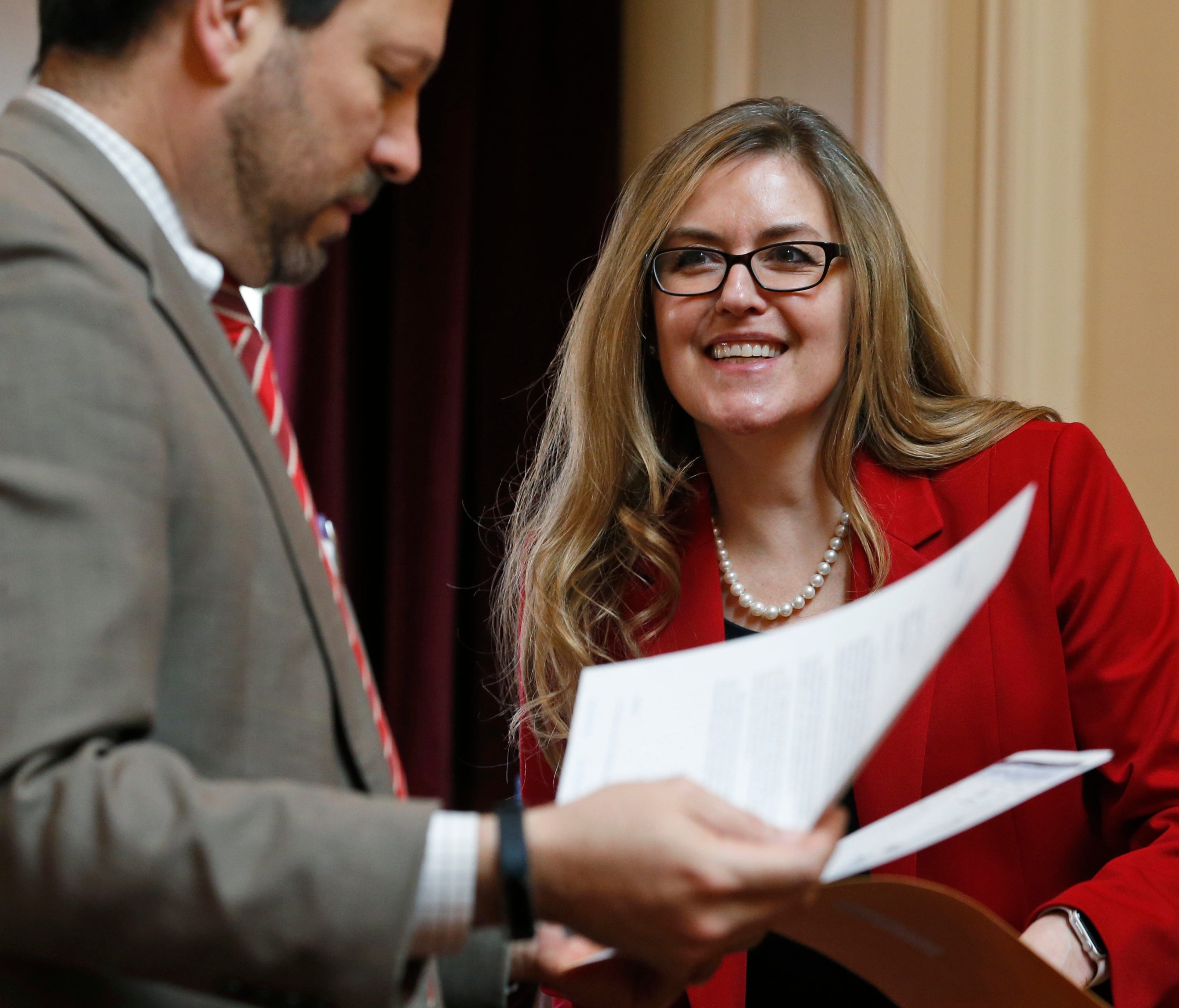 In this Wednesday, April 11, 2018 photo, Virginia State Sen. Jennifer Wexton, D-Loudon, center, talks with Sen. Scott Surovell, D-Fairfax, left, during the Senate special budget session at the Capitol in Richmond, Va. Wexton is one of the candidates 
