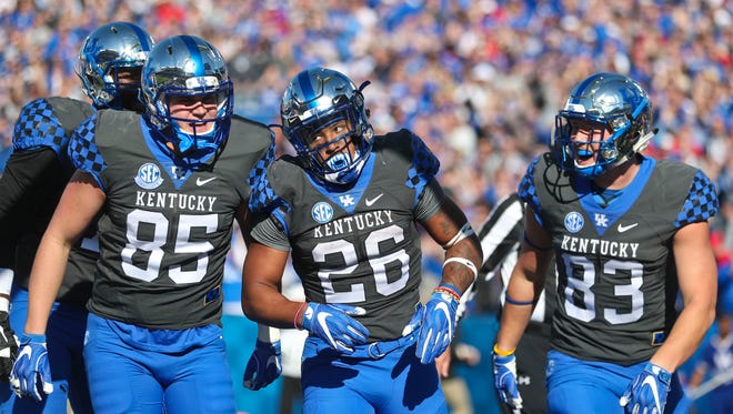Kentucky's Benny Snell, #26, celebrates after this rushing touchdown in the first quarter during the Louisville-Kentucky football game at Kroger Field Saturday Nov. 25. Snell tied the single-season school record for rushing TDs with this score.