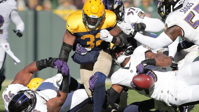 Green Bay Packers running back Devante Mays fumbles in the first half against the Baltimore Ravens on Sunday, November 19, 2017, at Lambeau Field in Green Bay, Wis.