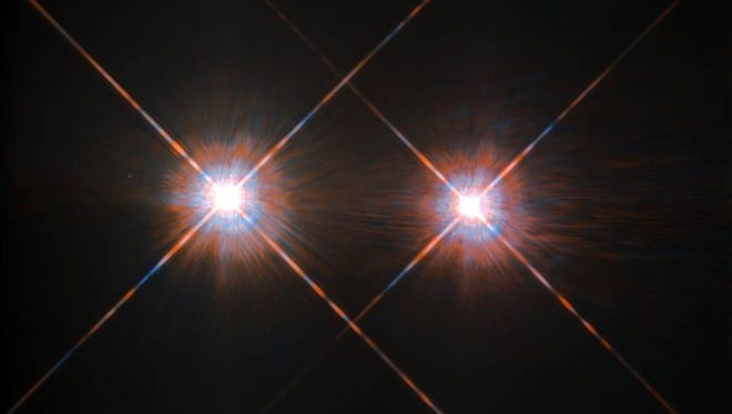 The closest star system to the Earth is the famous Alpha Centauri group. Located in the constellation of Centaurus (The Centaur), at a distance of 4.3 light-years, this system is made up of the binary formed by the stars Alpha Centauri A and Alpha Centauri B, plus the faint red dwarf Alpha Centauri C, also known as Proxima Centauri. The NASA/ESA Hubble Space Telescope has given us this stunning view of the bright Alpha Centauri A (on the left) and Alpha Centauri B (on the right), flashing like huge cosmic headlamps in the dark. The image was captured by the Wide Field and Planetary Camera 2 (WFPC2). WFPC2 was Hubble’s most used instrument for the first 13 years of the space telescope’s life, being replaced in 2009 by WFC3 during Servicing Mission 4. This portrait of Alpha Centauri was produced by observations carried out at optical and near-infrared wavelengths. Compared to the Sun, Alpha Centauri A is of the same stellar type G2, and slightly bigger, while Alpha Centauri B, a K1-type star, is slightly smaller. They orbit a common centre of gravity once every 80 years, with a minimum distance of about 11 times the distance between the Earth and the Sun. Because these two stars are, together with their sibling Proxima Centauri, the closest to Earth, they are among the best studied by astronomers. And they are also among the prime targets in the hunt for habitable exoplanets. Using the HARPS instrument astronomers already discovered a planet orbiting Alpha Centauri B. In August 2016 astronomers announced the discovery of an Earth-like planet in the habitable zone orbiting the star Proxima Centauri. Links:  Pale Red Dot Campaign  ESO press release on Proxima Centauri 
