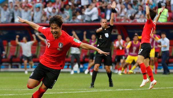 South Korea's Kim Young-gwon celebrates scoring...