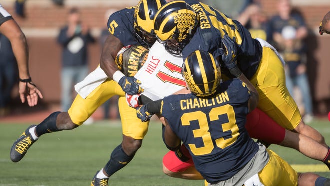 Maryland quarterback Perry Hills is sacked by the Michigan defense in the first quarter.