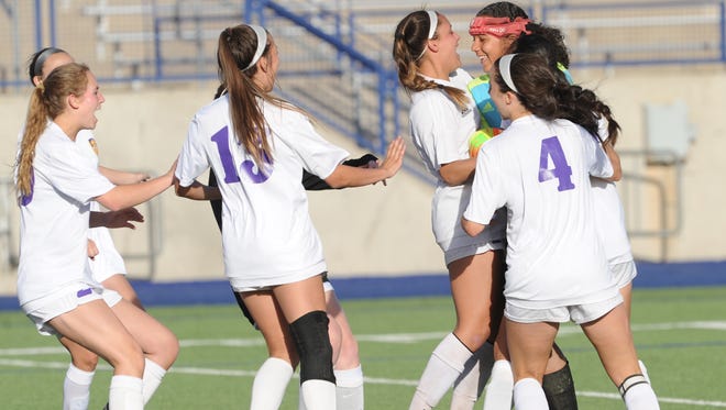 Wylie players mob goalie Arianna Taylor after San Elizario's fifth and final shooter misses wide right, giving the Lady Bulldogs a 4-3 shootout victory in the Region I-4A area  playoff game Tuesday, April 3, 2018 in Midland.
