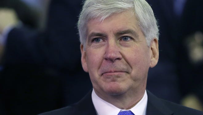 FILE - In this Feb. 11, 2015 file photo, Michigan Gov. Rick Snyder gets ready for an address in Lansing, Mich. Snyder used his extraordinary legal powers in December to pardon a politically connected lawyer who had a  drunken driving conviction. (AP Photo/Carlos Osorio, File)