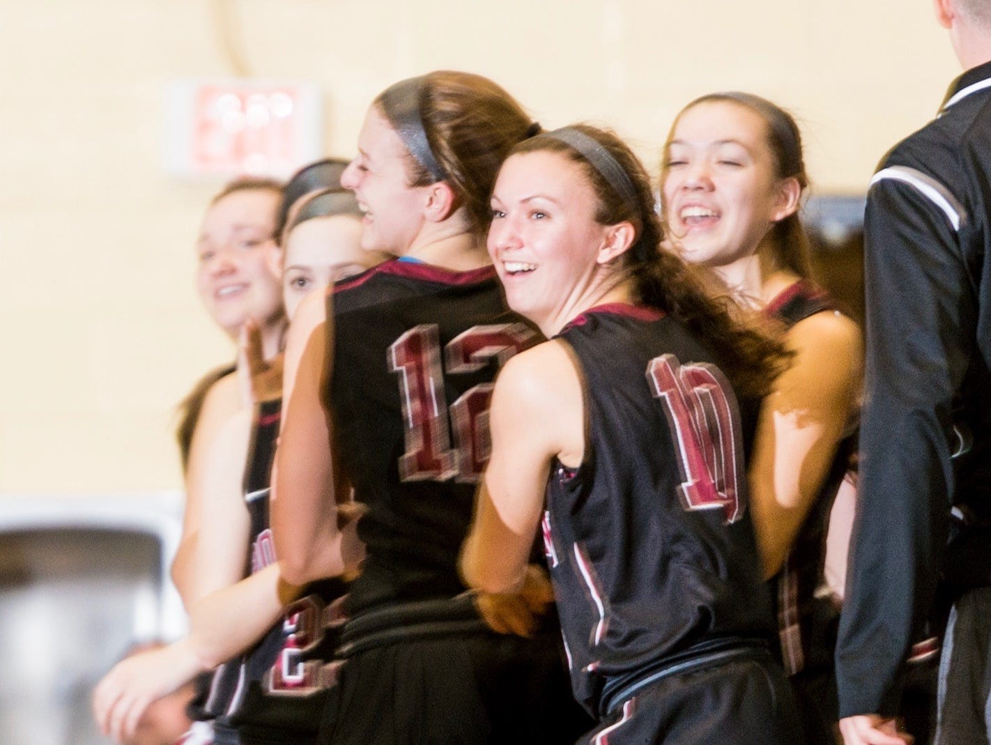 The Portland bench celebrates as time expires in their Class B regional semifinal win over Eaton Rapids Tuesday March 7, 2017 at Don Johnson Fieldhouse in Lansing.