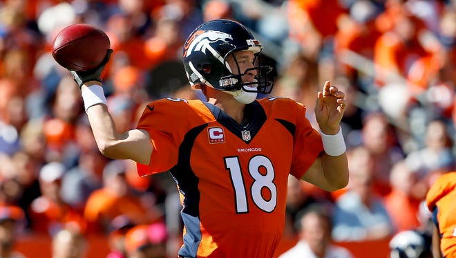 Denver Broncos quarterback Peyton Manning (18) throws against the Arizona Cardinals during the first half of an NFL football game, Sunday, Oct. 5, 2014, in Denver.