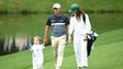 Kevin Kisner walks with daughter Kate and wife Brittany