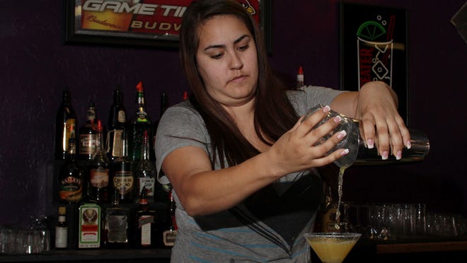 Marybell Aquayo practices making margarita in the Bartending Academy in Tempe. She wants to be a bartender because it allows her to express her creativity by mixing drinks.