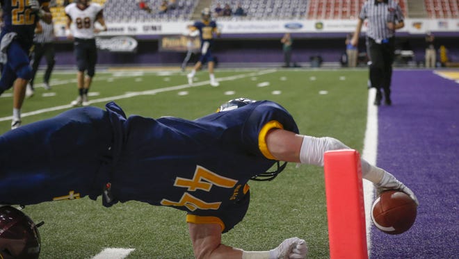 Iowa City Regina junior running back Isaac Vollstedt reaches into the end zone for a touchdown against Denver during the semifinals of the 2016 Iowa high school football tournament on Saturday, Nov. 12, 2016, at the UNI-Dome in Cedar Falls.
