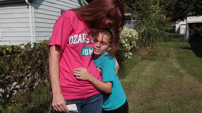 Elizabeth Lang hugs her son, Jacob Hernandez, 9, after he was hit by a car on his way home from school at North Clifton Avenue and West Calhoun Street on Monday, August 31, 2015. The boy's injuries were minor, but Lang was upset that the driver left the scene.