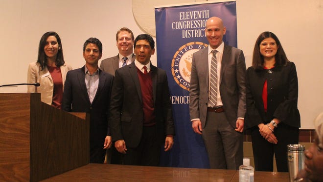 Candidates running for the Democratic nomination in the 11th Congressional District take a photo at a debate Saturday in Novi. From left to right: Fayrouz Saad, Suneel Gupta, Tim Greimel, moderator Hansen Clarke, Dan Haberman and Haley Stevens.