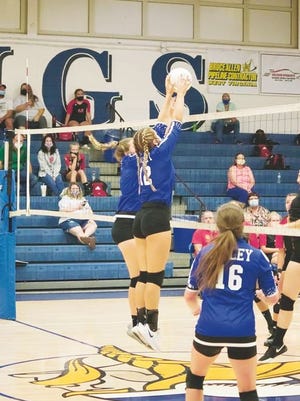 Ciara McDowell, No. 12, and Maddie Fields go up for the block, while Kirsten Hinzman, No. 16, covers.