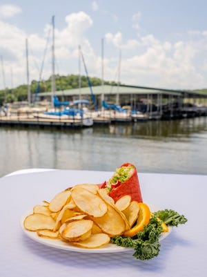 Sliced turkey, lettuce, tomato, swiss cheese and avocado are wrapped in a tomato basil or spinach tortilla with garlic and dill aioli make up the Wheelhouse Avocado Wrap.