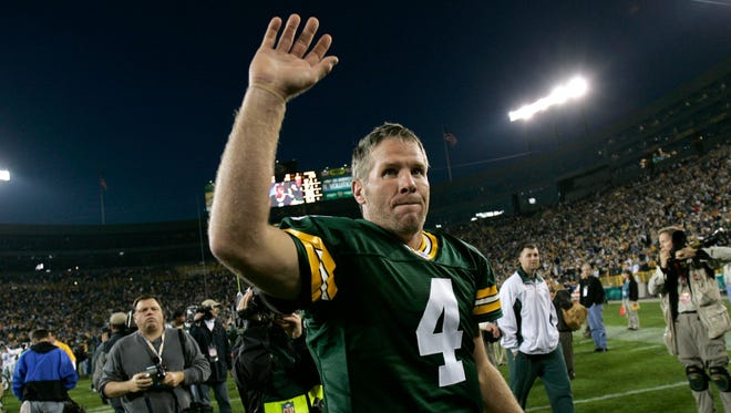 Green Bay Packers quarterback Brett Favre waves to the Lambeau Field crowd after defeating the Dallas Cowboys on Oct. 24, 2004.