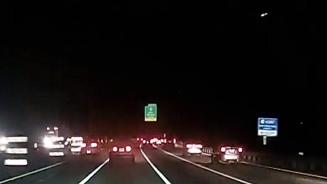 In this screen capture from a dash-cam video, a meteor can be seen in the top right corner as it descends over Route 287 south in the Cedar Knolls section of Hanover on Monday, Dec. 29, 2014.
