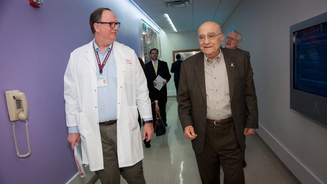 St. Jude Children’s Research Hospital Scientist Dr. Geoffrey Neale and Shreveporter Dr. Donald G. Mack Sr. visit as they walk down a hall at St. Jude, Memphis, Tenn.