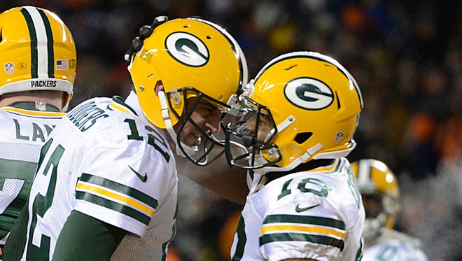 Green Bay Packers receiver Randall Cobb (18) is congratulated by teammate Aaron Rodgers after the two connected on a touchdown reception in the third quarter against the Chicago Bears at Soldier Field in Chicago.