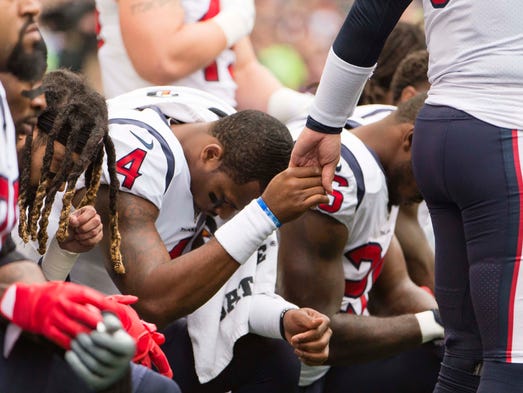 Oct. 29: Texans quarterback Tom Savage, right, holds
