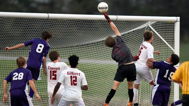 Henderson County goalkeeper Dylan McGaha pokes the ball away after a Lyon County cross during the first half of the the Boys Second Region Soccer Tournament at Donley Field in Madisonville Tuesday.  Henderson won 6-1.