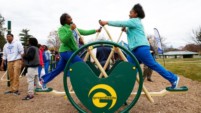 Yonnae Hobbs, 15, and Jae'Onna Palmer, 16, use the elliptical machine at the Greater Cincinnati Outdoor Gym, a free outdoor gym at Roselawn Park.