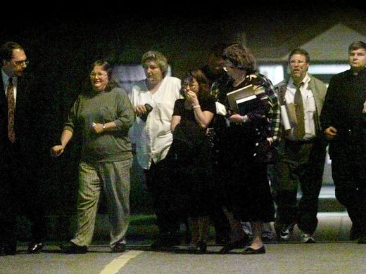 Members of the Robert Glenn Coe family leave the Riverbend