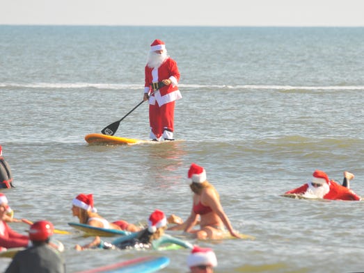 Thousands turned out to watch hundreds of surfing Santas