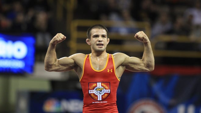 Former Hawkeye Tony Ramos celebrates his win over Coleman Scott in the 125.5-pound (57 kilo) freestyle weight division at the U.S. Wrestling Olympic Team Trials at Carver-Hawkeye Arena on Sunday, April 10, 2016.