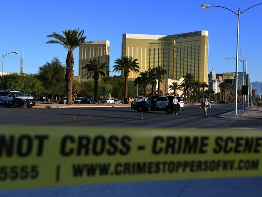 Crime scene tape surrounds the Mandalay Hotel (background)