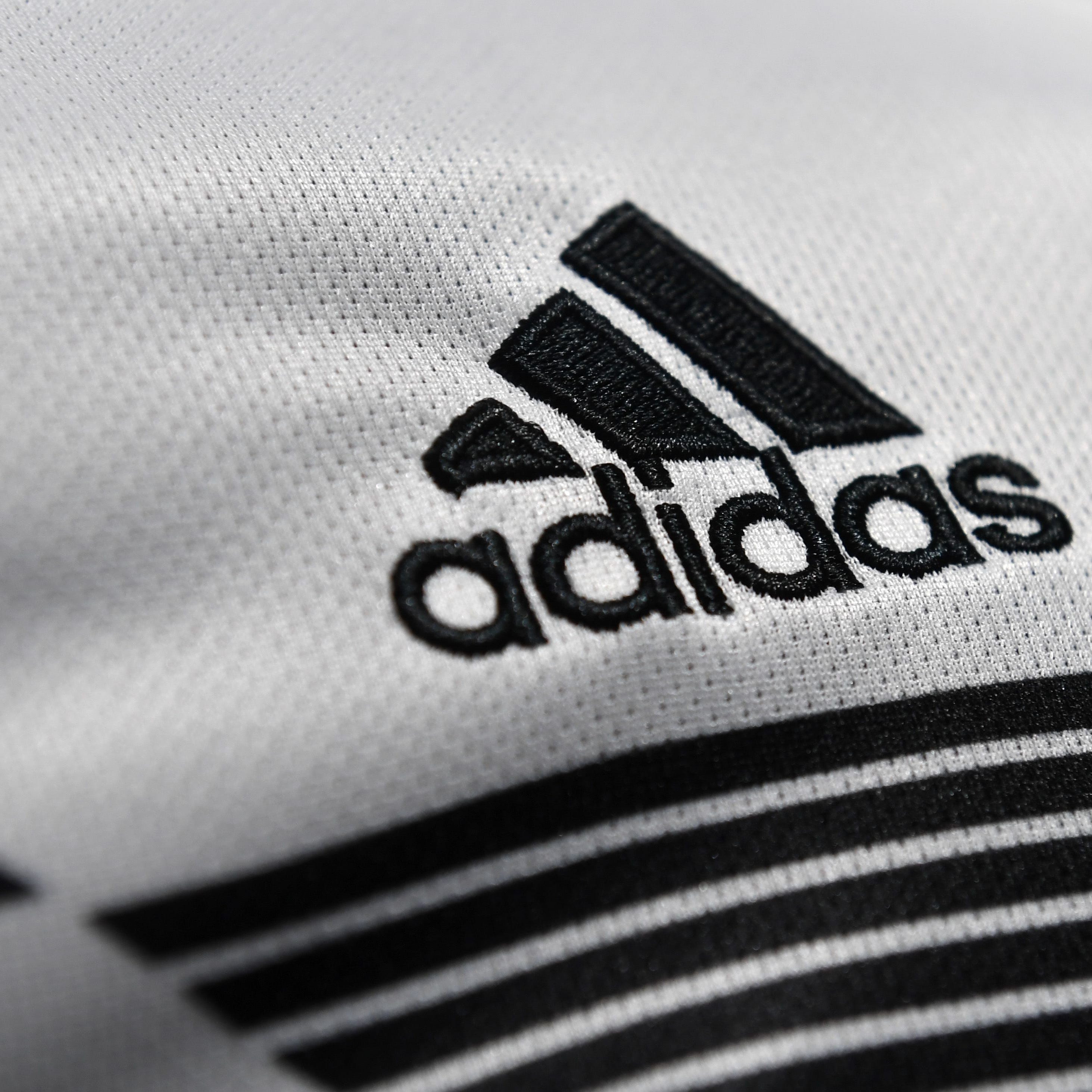 The Adidas company logo is on display during the company's annual press conference of Germany's sportgoods company Adidas in Herzogenaurach, southern Germany, on March 14, 2018.The company uses apps and other channels to sell directly to customers, rather than just offering its products in third party stores.