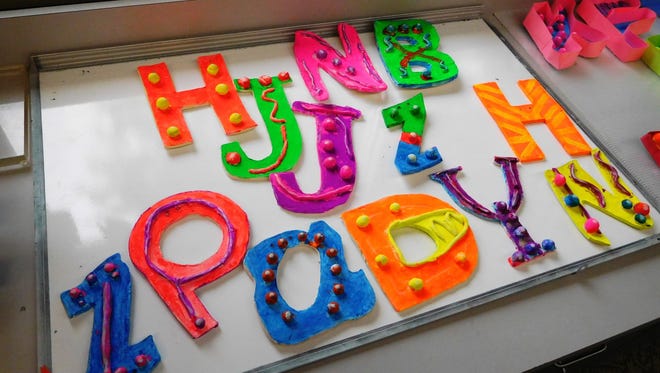 Rudiger students created neon colored letters for the project on road signs.