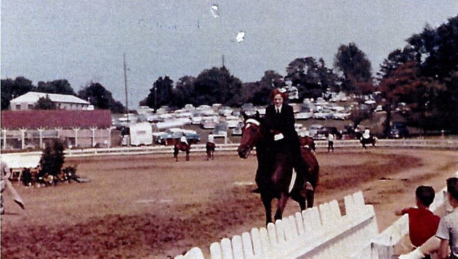 Susan Stearns (Wolfe) rides her horse, Sherry-Dawn at an event class at the Oldham County Fair, circa 1960.