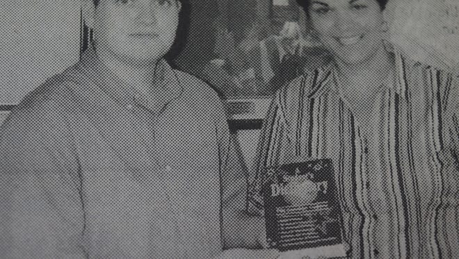 The Rotary Club of Union County distributed over 200 dictionaries to Union County third graders in October 2004. Here, Rotary president David Beaven presented a dictionary to Morganfield Elementary third grade teacher Cheryl Ladd.