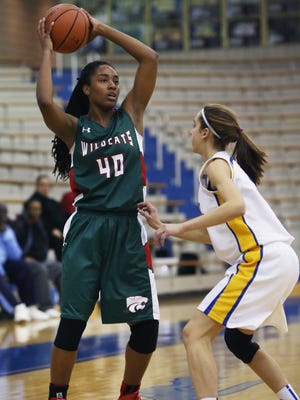 Carmel's Amy Dilk defends Lawrence North's Lamina Cooper as she sets to pass off to a teammate in the Wildcats' 56-50 win at Carmel on Tuesday, Dec. 2, 2014.