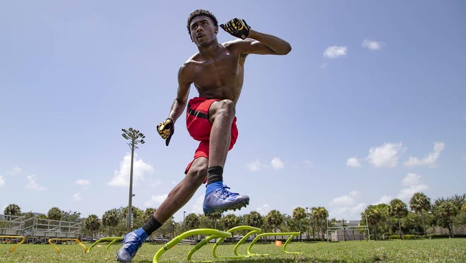 Jakyri West, 14, Loxahatchee, works on a back peddling drill. West workouts near Seminole Palms Park with a group of friends trained by Daniel Duncan and Luther Howard. The group works on football skills and conditioning three times a week in Royal Palm Beach, July 31, 2020.