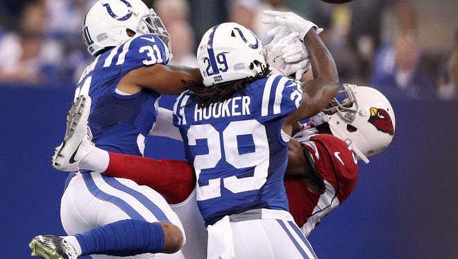 Indianapolis Colts cornerback Quincy Wilson (31) and Malik Hooker (29) break up a pass intended for Arizona Cardinals wide receiver Jaron Brown (13) in the first half of their game at Lucas Oil Stadium Sunday, Sept, 17, 2017.