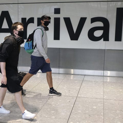 Passengers arrive at Heathrow Airport in London Ju