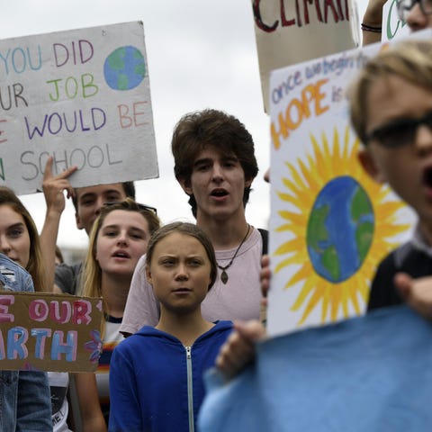 Swedish youth climate activist Greta Thunberg, cen