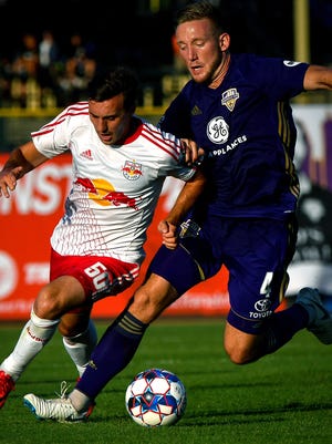 Louisville City FC defender Sean Totsch (4) plays against New York Red Bulls II midfielder Jared Stroud (50) during the soccer match at Slugger Field in Louisville, Ky, June 30, 2018.