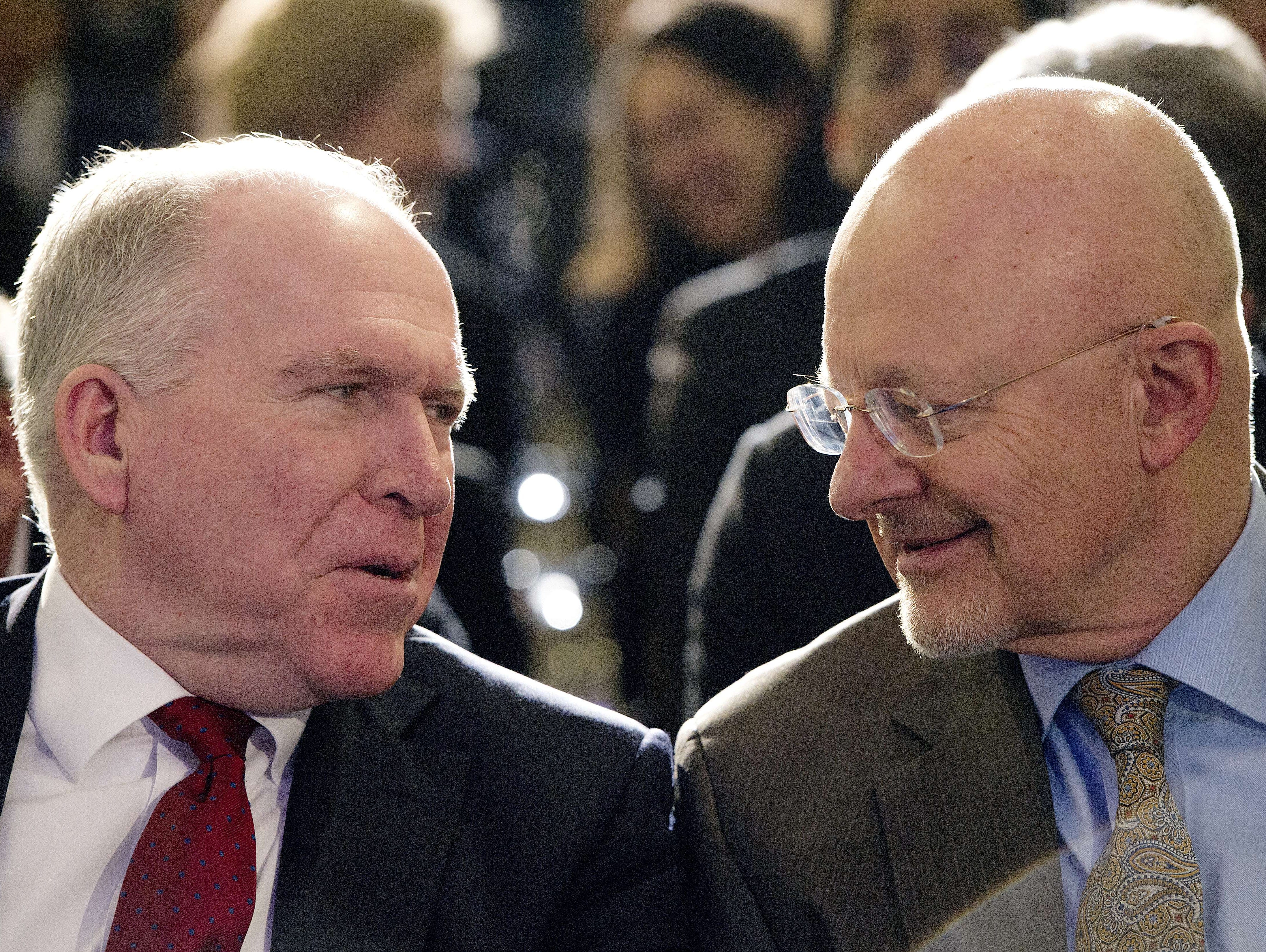 Director of the Central Intelligence Agency (CIA) John Brennan (left) talks with the Director of National Intelligence James Clapper  before President Obama spoke about the National Security Agency (NSA) and intelligence agencies surveillance techniq