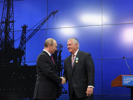 Russian President Vladimir Putin and Tillerson shake