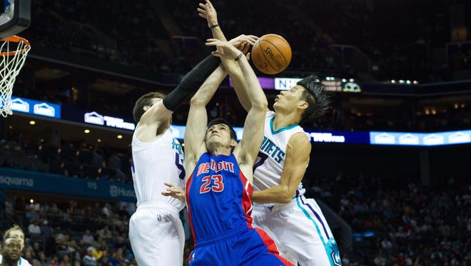 Dec 7, 2015; Charlotte, NC, USA; Detroit Pistons forward Ersan Ilyasova (23), Charlotte Hornets center Frank Kaminsky III (44) and guard Jeremy Lin (7) try to grab a rebound during the first half at Time Warner Cable Arena.