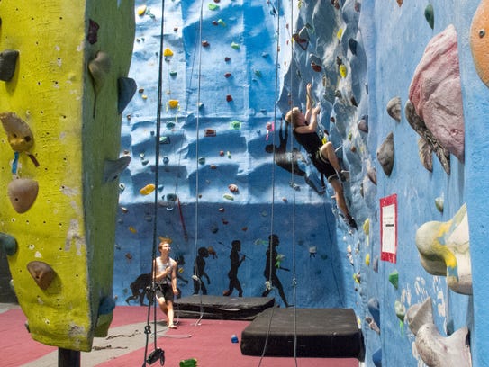 Sheldon Cummings belays while Shaun Cummings climbs