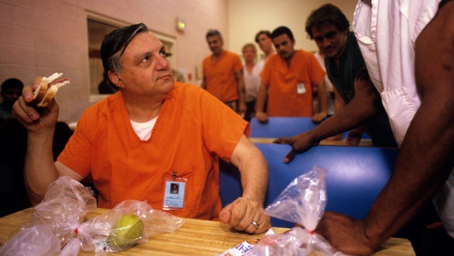 May 1995: Sheriff Joe Arpaio chats with inmates inside Tent City on May 10, 1995.  Arpaio stayed inside Tent City for a night to prove it was safe, and an inmate could survive without "luxuries" such as hot lunches, coffee and cigarettes.