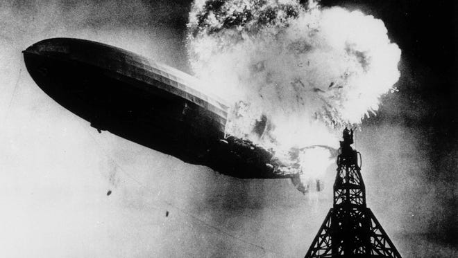 FILE - This May 6, 1937 file photo, provided by the Philadelphia Public Ledger, was taken at almost the split second that the Hindenburg exploded over the Lakehurst Naval Air Station in Lakehurst, N.J. Only one person is left of the 62 passengers and crew who survived when the Hindenburg burst into flames 80 years ago Saturday, May 6, 2017. Werner Doehner was 8 years old when he boarded the zeppelin with his parents and older siblings after their vacation to Germany in 1937. The 88-year-old now living in Parachute, Colo., tells The Associated Press that the airship pitched as it tried to land in New Jersey and that "suddenly the air was on fire." (AP Photo, File)