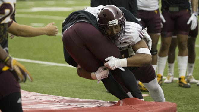 ASU's Armand Perry (13) makes a tackle during a practice earlier this month.