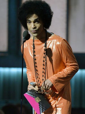 This Feb. 8, 2015, file photo shows Prince as he presents an award on stage at the 57th Annual Grammy Awards in Los Angeles.  Prince died Thursday, April 21, at age 57.