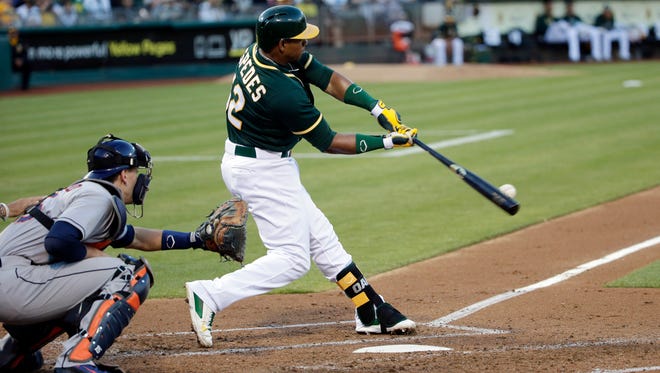 FILE - In this July 23, 2014 file photo, Oakland Athletics' Yoenis Cespedes hits a three-run home run against the Houston Astros during the second inning of a baseball game in Oakland, Calif. A person with knowledge of the trade says the Athletics have won the Jon Lester sweepstakes, acquiring the left-hander along with outfielder Jonny Gomes from the Red Sox for slugging outfielder Yoenis Cespedes before Thursday's, July 31, 2014,  trade deadline. The person spoke on condition of anonymity because neither club announced the deal. (AP Photo/File)
